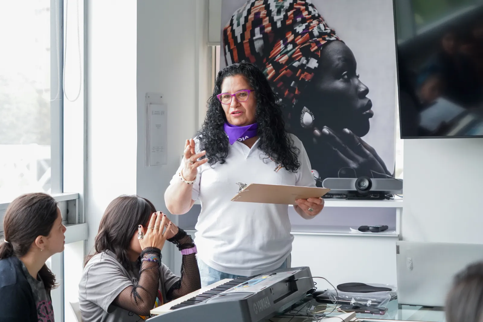 A foundation facilitator explains an activity while the participants listen.